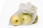 View Of Some Yellow Apples Inside A Plastic Bag Stock Photo