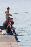 Men Fishing Off The Quayside At The Harbour In Funchal Stock Photo
