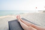 Girl Leg Lay On Sunbed At Beach Stock Photo
