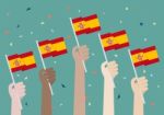 Hands Holding Up Spain Flags Stock Photo