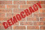 Old Brick Wall Texture With Democracy Inscription Stock Photo