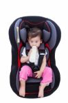 Girl Suck Up Milk At Car-seat And Fasten Seat Belt Stock Photo