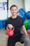Happy Man Doing Stretching Exercises In A Health Club Stock Photo