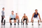 Multiethnic Group With Weightlifting Bar Workout In Fitness Cent Stock Photo