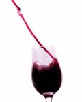 Red Wine Flowing Into The Glass Stock Photo