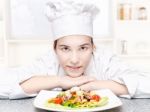 Pretty Young Chef And Hers Plate Of A Delicious Salad In Kitchen Stock Photo