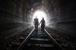 Couple Walking Together Through A Railway Tunnel Stock Photo