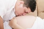 Man Kiss A Stomach Of The Pregnant Woman Stock Photo