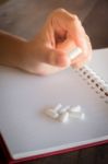 Hand On White Pill Medicine Stock Photo