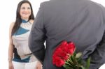 Man With A Bouquet Of Red Roses Watching His Woman Isolated, Val Stock Photo