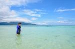 Asian Woman Walking In The Sea At Travel To Koh Lipe Island Stock Photo