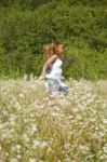 Woman Running In Meadow Stock Photo