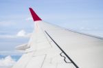 Plane Wing On Cloudy Blue Sky Background Stock Photo