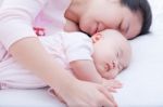 Newborn Baby Girl Sleeping In Mother Arm Stock Photo