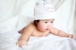 Newborn Baby With Cow Hat Lying Down On A White Blanket Stock Photo