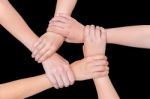 Five Arms Of Children Holding Together On Black Background Stock Photo