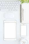 Phone And Tablet Blank Screen On White Table Format Vertical Top Stock Photo