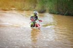 Motocross Is Trying To Drive Across The River Stock Photo
