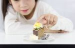 Little Girl Touching Cake Stock Photo