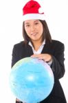 Woman With Santa Hat And Globe Stock Photo