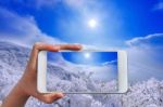 Hand Holding Smart Phone Take A Photo At Deogyusan Mountains In Winter Stock Photo