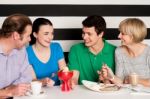 Happy Family Of Four In Restaurant Stock Photo