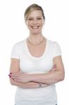 Smiling Woman With Arms Crossed Stock Photo