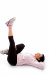 Side View Of Laying Exercising Woman On White Background Stock Photo