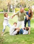 Family Holding Back Grandfather Stock Photo