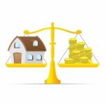 House And Money On Balance Scale Stock Photo