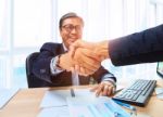 Two Business Man Shaking Hand With Happiness Emotion After Agreement In Working Solution ,shot On Office Working Table Stock Photo