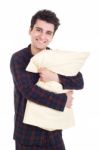 Man In Pajamas Holding Pillow Stock Photo