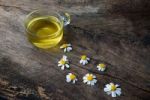 Chamomile Tea And Chamomile Flower On Old Wooden Table Stock Photo