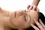 Front View Of Female Taking Head Massage Stock Photo
