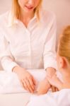 Masseuse Massaging Young Woman's Hand Stock Photo