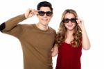 Young Couple Posing To Camera With Shades On Stock Photo