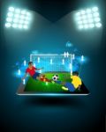 Football Player Striking The Ball On Tablet Stock Photo