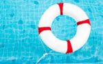 Life Ring At The Swimming Pool. Life Ring On Water. Life Ring On Stock Photo
