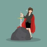 Business Woman Try To Pull Sword From Stone Stock Photo