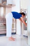 Woman Opening The Refrigerator Stock Photo