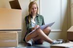 Young Beautiful Woman Moving In New Home Stock Photo