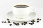 White Cup Of Coffee On Beans Stock Photo