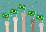 Hands Holding Up Brazil Flags Stock Photo