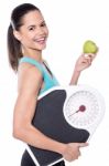 Happy Lady Posing With Weighing Scale And Apple Stock Photo
