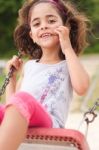 Lovely Girl On A Swing In The Park Stock Photo