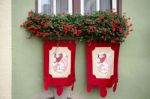 Red Geraniums And Flags On A House In Rothenburg Stock Photo