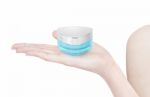 Blue Triangle Cosmetic Jar On Hand Isolated Stock Photo