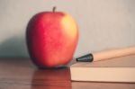 Pencil With Apple On Desk Stock Photo