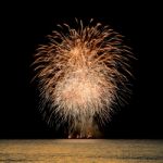 Firework Celebration From The Sea Shore Stock Photo