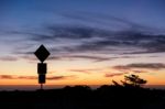 Road Sign Silhouette And Colorful Sunset Stock Photo